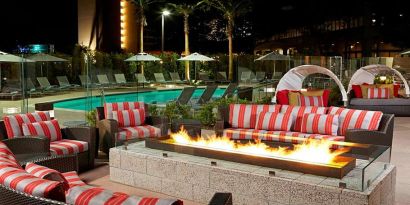 Beautiful outdoor patio by the pool with firepit at Residence Inn By Marriott LAX Airport.