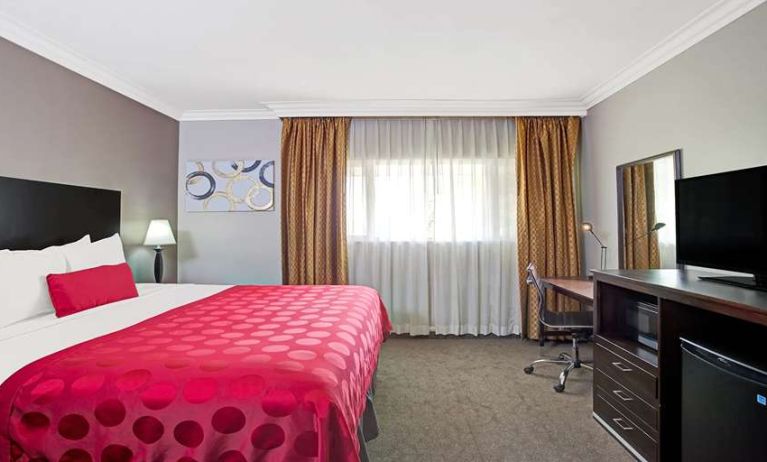 King bedroom with desk at Ramada Los Angeles Downtown West.