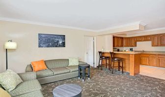 Living room with kitchenette and sofa at Ramada Los Angeles Downtown West.