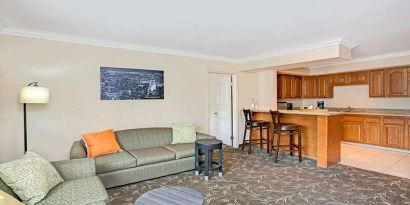 Living room with kitchenette and sofa at Ramada Los Angeles Downtown West.