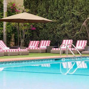 Outdoor seating area by the pool at Hollywood Hotel.