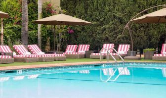 Outdoor seating area by the pool at Hollywood Hotel.