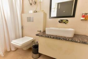 clean and spacious guest bathroom with shower at Hotel Luxury Stay.