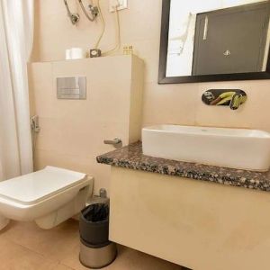 clean and spacious guest bathroom with shower at Hotel Luxury Stay.