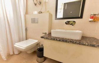 clean and spacious guest bathroom with shower at Hotel Luxury Stay.