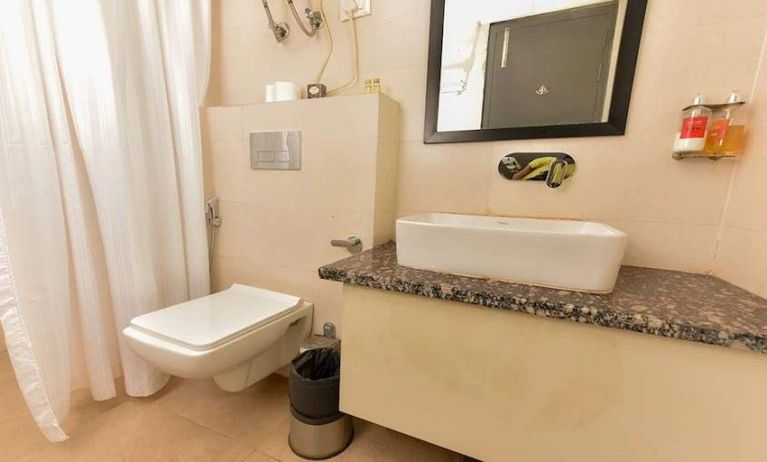 clean and spacious guest bathroom with shower at Hotel Luxury Stay.