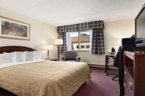 Hotel bedroom with TV screen and desk at Travelodge Ottawa East.