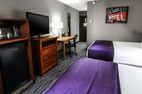 Twin room with TV screen and desk at Best Western McCarran Inn.