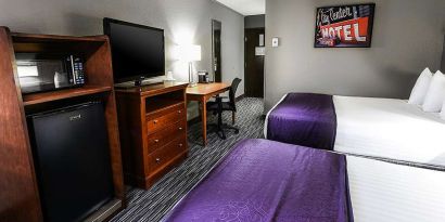 Twin room with TV screen and desk at Best Western McCarran Inn.