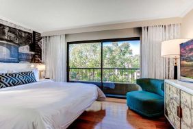 King bedroom with big window at Avenue Of The Arts Hotel.