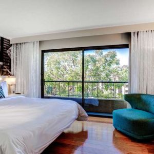 King bedroom with big window at Avenue Of The Arts Hotel.