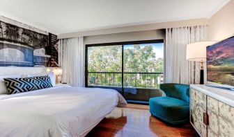 King bedroom with big window at Avenue Of The Arts Hotel.