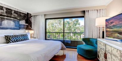 King bedroom with big window at Avenue Of The Arts Hotel.