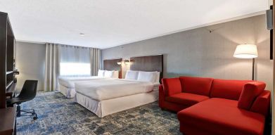 Twin room with L sofa at Four Points By Sheraton Toronto Mississauga.