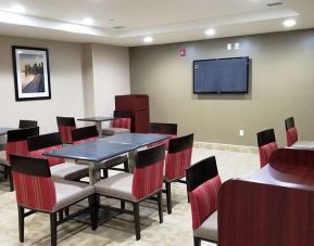 Seating area with TV screen at Days Inn Brooklyn Marine Park.