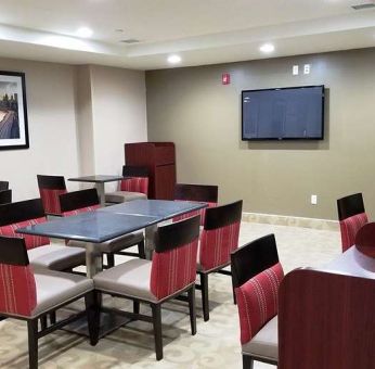 Seating area with TV screen at Days Inn Brooklyn Marine Park.