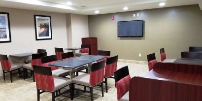 Seating area with TV screen at Days Inn Brooklyn Marine Park.