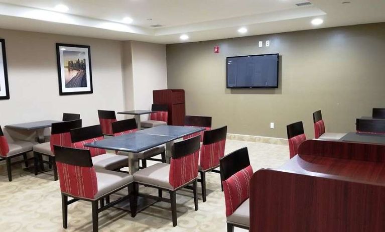 Seating area with TV screen at Days Inn Brooklyn Marine Park.