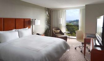 Bright king bedroom with window and workstation at Atlanta Marriott Northwest At Galleria.