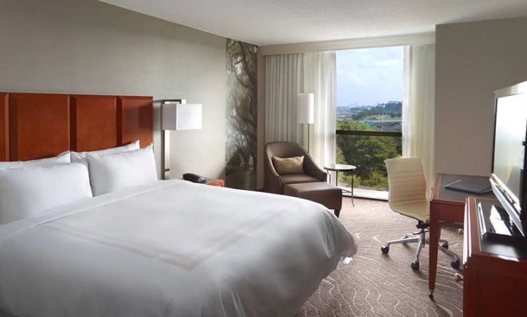 Bright king bedroom with window and workstation at Atlanta Marriott Northwest At Galleria.