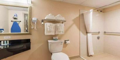 Clean and spacious guest bathroom with shower at Quality Inn Pasadena.