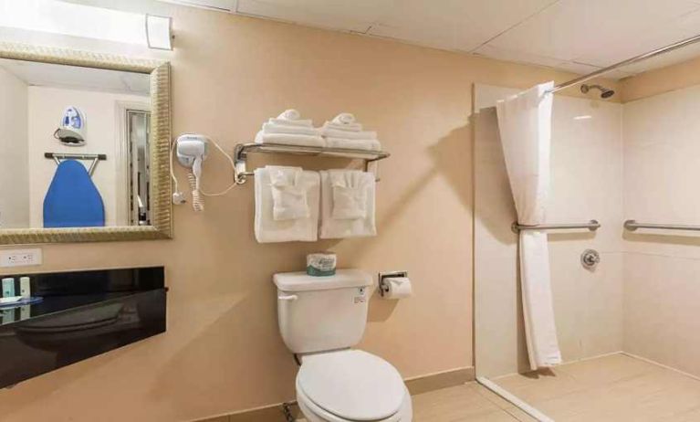 Clean and spacious guest bathroom with shower at Quality Inn Pasadena.