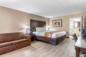 Spacious king suite with couch and TV at Quality Inn Pasadena.