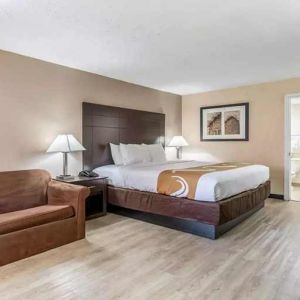 Spacious king suite with couch and TV at Quality Inn Pasadena.