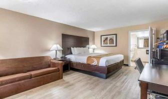 Spacious king suite with couch and TV at Quality Inn Pasadena.