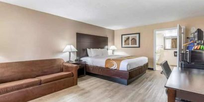 Spacious king suite with couch and TV at Quality Inn Pasadena.