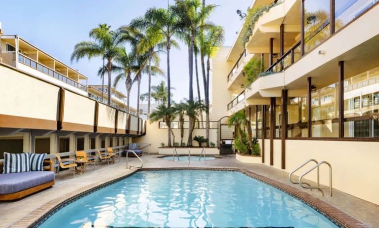 Lovely outdoor pool with seating area at Pacific Edge Hotel.