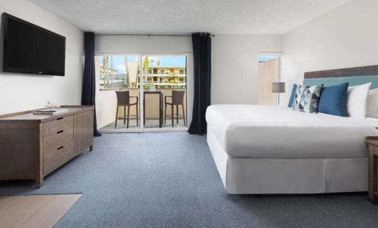 Spacious delux king with TV, balcony, and lots of natural light at Pacific Edge Hotel.