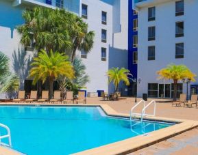 Large outdoor pool with sunbeds at Southbank Hotel Jacksonville Riverwalk.
