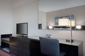 King room equipped with business desk at Courtyard By Marriott New York JFK Airport.