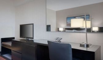 King room equipped with business desk at Courtyard By Marriott New York JFK Airport.