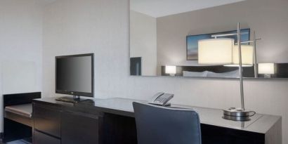 King room equipped with business desk at Courtyard By Marriott New York JFK Airport.