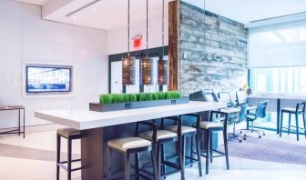 Comfortable open plan seating with plug points for laptops ideal for working remotely at Courtyard By Marriott New York JFK Airport.