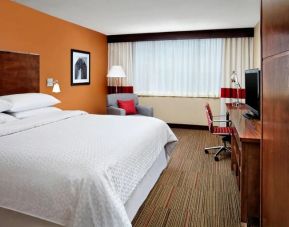 Spacious king bedroom with work desk and TV at Four Points by Sheraton Halifax.