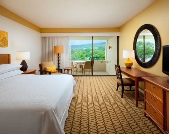 Luxurious king room with TV, terrace, work desk and lots of natural light at Outrigger Kona Resort And Spa.
