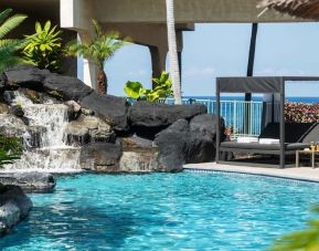 Stunning outdoor pool with sunbeds at Outrigger Kona Resort And Spa.