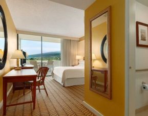 Lovely king suite with TV, business desk, and balcony at Outrigger Kona Resort And Spa.