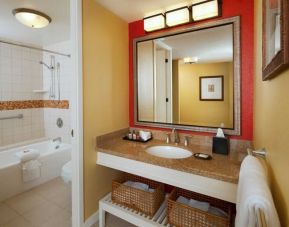 Spacious guest bathroom with shower and bath at Outrigger Kona Resort And Spa.