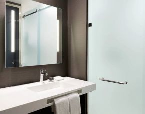 Guest bathroom with shower at AC Hotel by Marriott Miami Aventura.