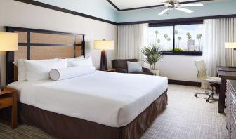 Comfortable king bedroom with couch and work station at The Ambrose Hotel Santa Monica.