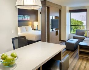 Luxurious delux king room with TV, lounge, and kitchen area at Hyatt House Seattle Downtown.