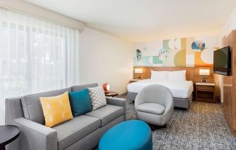 Spacious king suite with TV and lounge area at Clementine Hotel & Suites Anaheim.