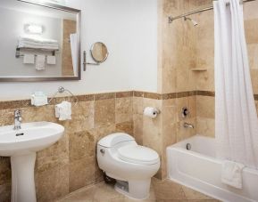Private guest bathroom with shower and bath at Porto Vista Hotel.