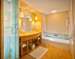 Spacious guest bathroom with bath at Marenas Beach Resort.