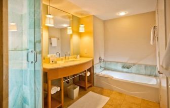 Spacious guest bathroom with bath at Marenas Beach Resort.