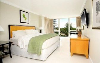 Comfortable king room with desk and TV at Ocean Manor Beach Resort.